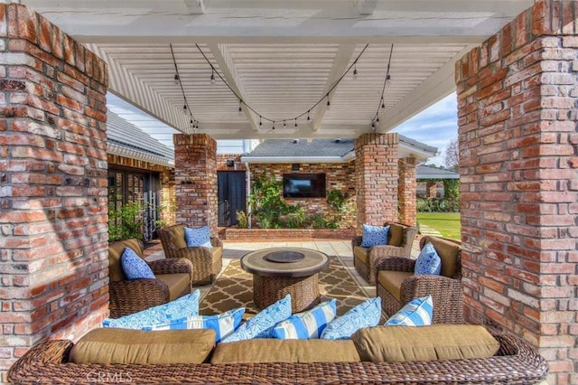 view of patio / terrace with an outdoor living space with a fire pit