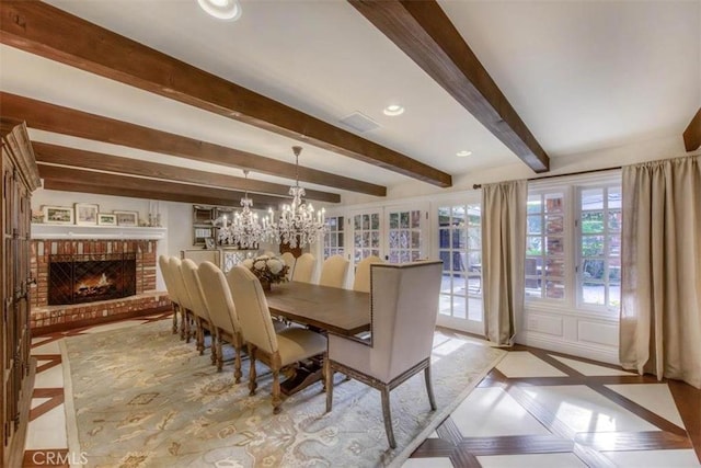 dining room featuring a fireplace, a notable chandelier, and beam ceiling