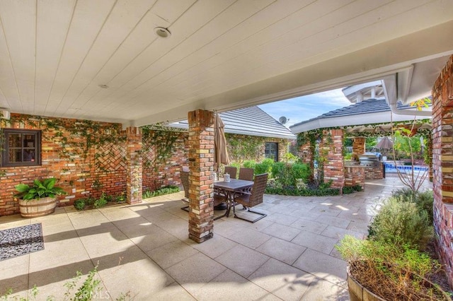 view of patio with exterior kitchen and a gazebo