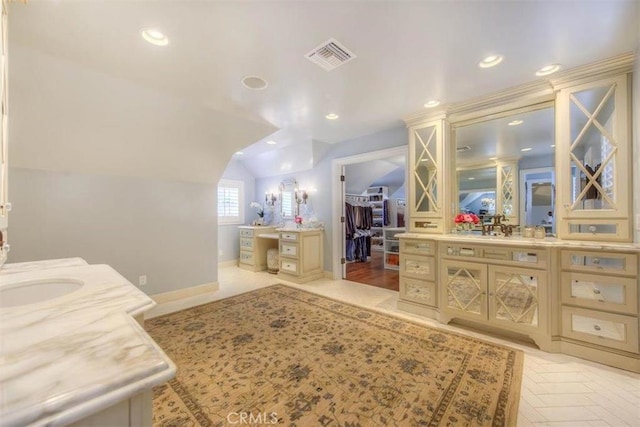 bathroom featuring vaulted ceiling, parquet floors, and vanity