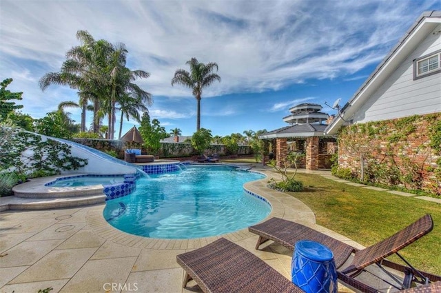 view of pool featuring pool water feature, a yard, an in ground hot tub, and a patio