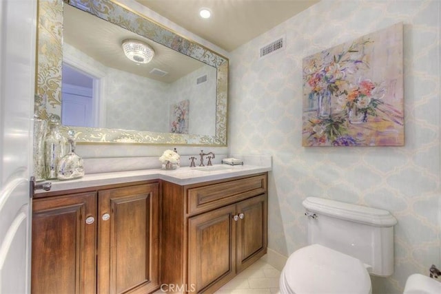 bathroom featuring toilet, tile patterned floors, and vanity