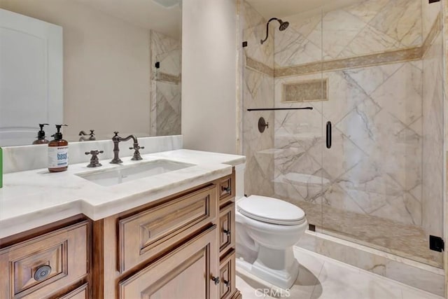 bathroom with a shower with door, vanity, and toilet