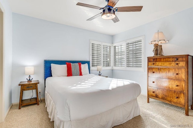 bedroom with ceiling fan and light carpet