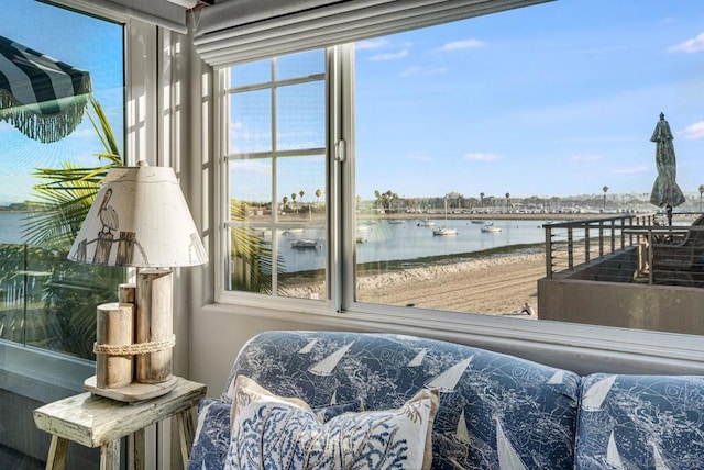 sunroom featuring a water view