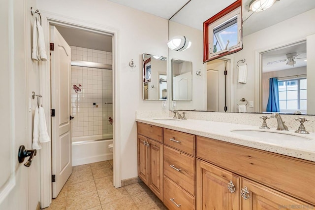 full bathroom with vanity, ceiling fan, shower / bath combination with glass door, tile patterned flooring, and toilet