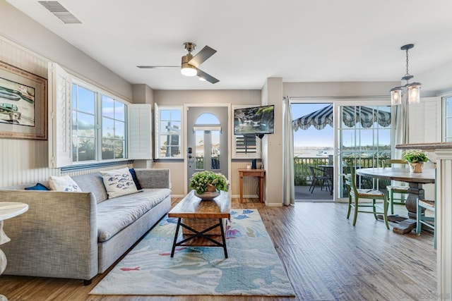 living room with ceiling fan and hardwood / wood-style flooring