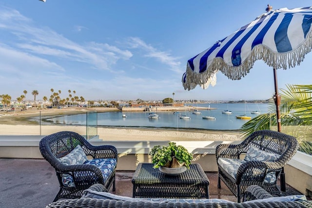 view of patio with outdoor lounge area and a water view