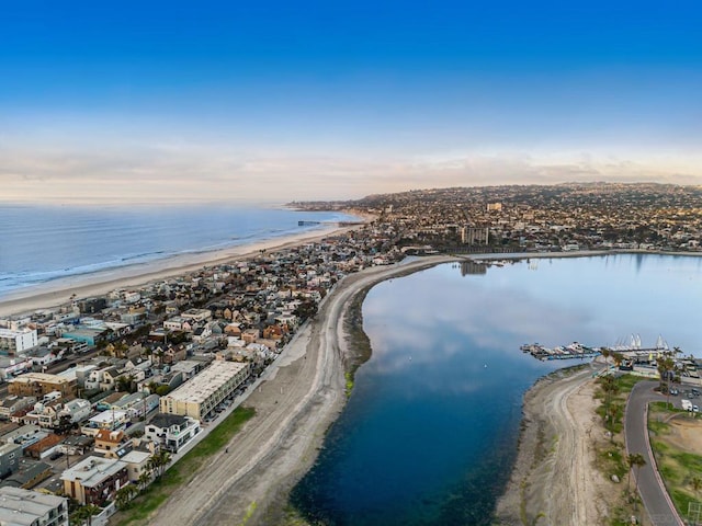 birds eye view of property with a beach view and a water view