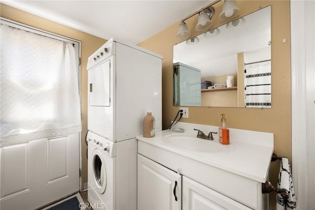 laundry area featuring stacked washer / dryer and sink