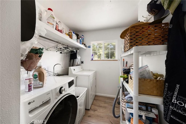 laundry room featuring light hardwood / wood-style floors and washer and clothes dryer