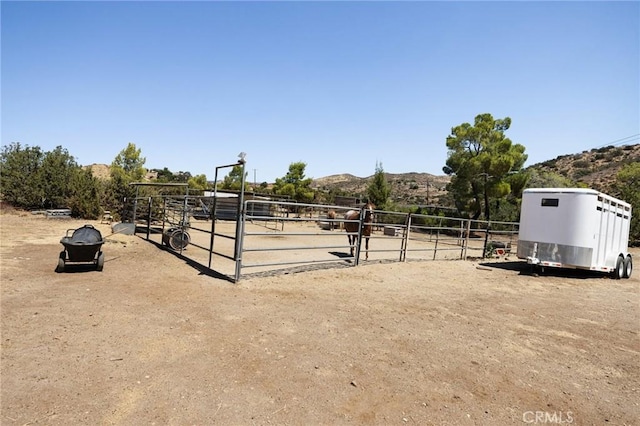 view of stable with a mountain view and a rural view