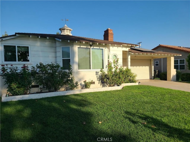 view of front of house with a carport, a garage, and a front lawn