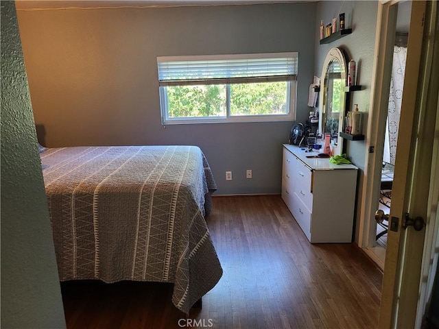 bedroom with dark wood-type flooring