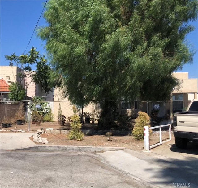 obstructed view of property featuring stucco siding and fence