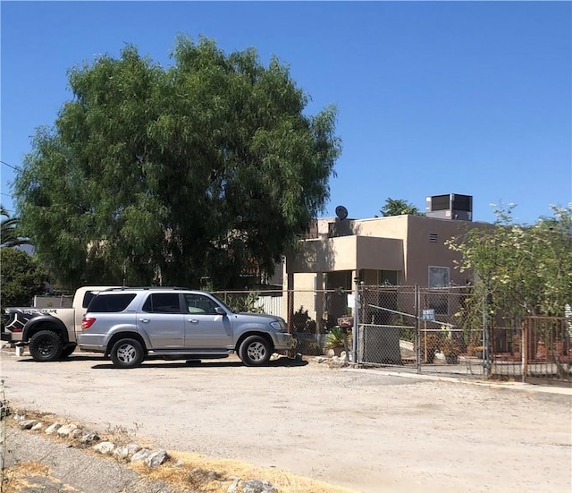 view of parking with fence