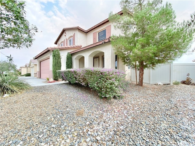 mediterranean / spanish-style home with a garage