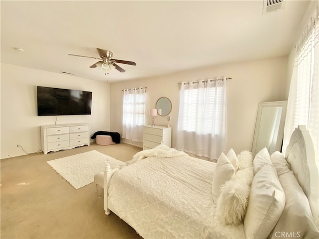 bedroom featuring light carpet and ceiling fan