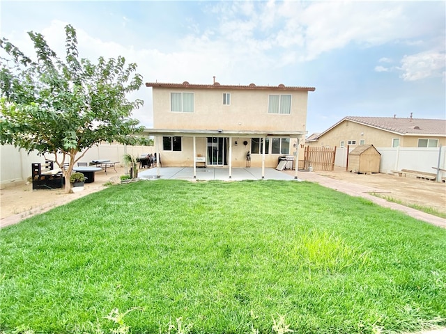 back of property featuring a lawn and a patio