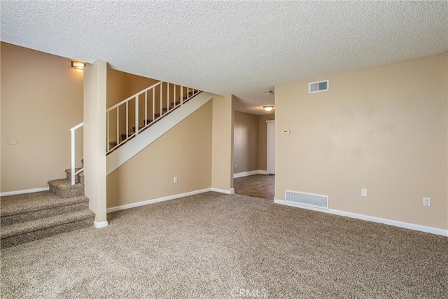 interior space with a textured ceiling and carpet