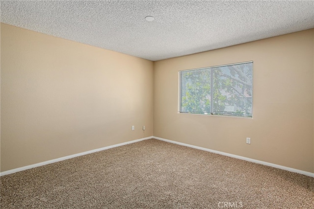 carpeted spare room featuring a textured ceiling