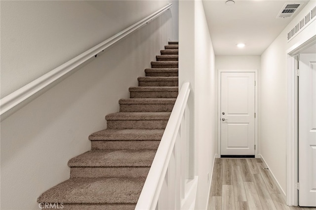 stairs with hardwood / wood-style floors