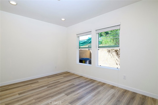 spare room with light hardwood / wood-style floors