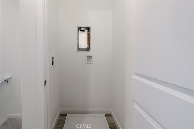 washroom with wood-type flooring and washer hookup