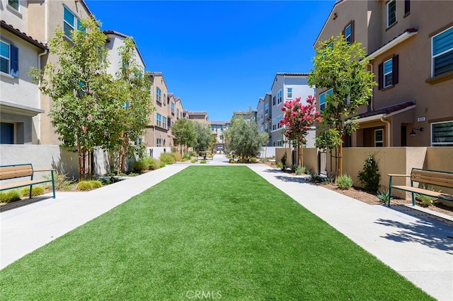 view of property's community with a yard