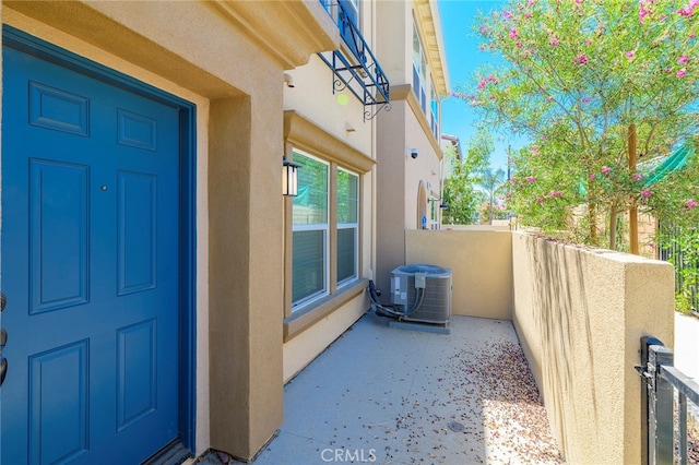 view of exterior entry featuring central AC unit