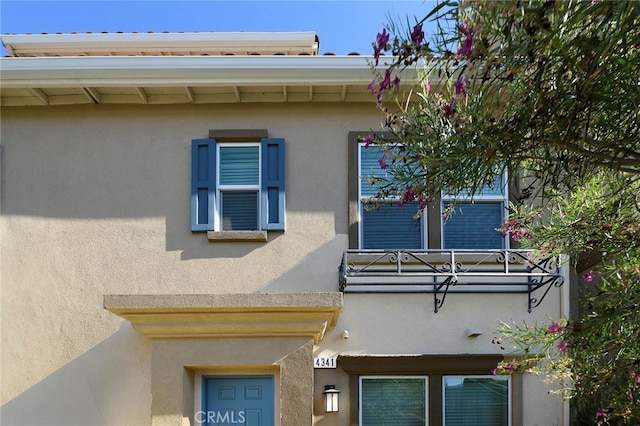 view of side of property featuring a balcony