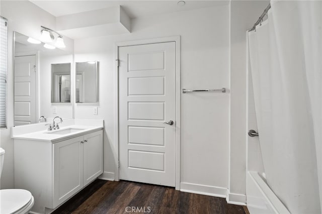 bathroom featuring vanity, hardwood / wood-style floors, and toilet