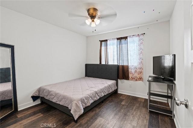 bedroom featuring ceiling fan and dark wood-type flooring