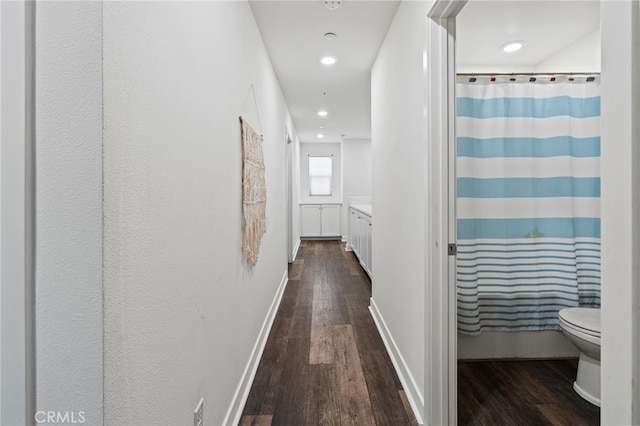 hallway with dark hardwood / wood-style floors