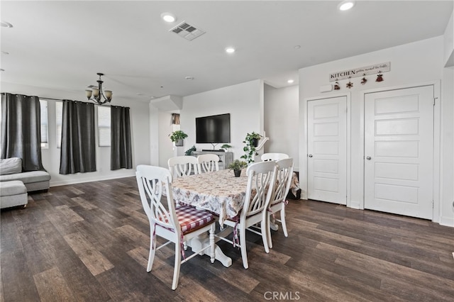 dining space featuring an inviting chandelier and dark wood-type flooring