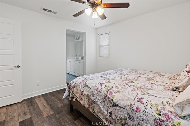 bedroom featuring ensuite bath, ceiling fan, and dark wood-type flooring