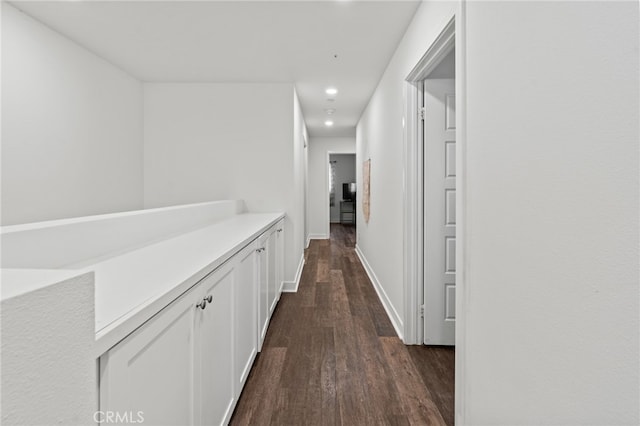 corridor with dark hardwood / wood-style flooring