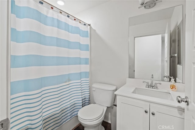 bathroom featuring vanity, toilet, and a shower with curtain