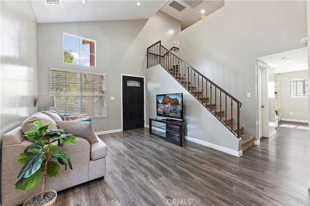 living room with high vaulted ceiling and hardwood / wood-style floors