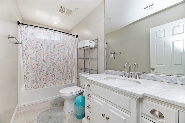 full bathroom featuring shower / bath combo, vanity, and toilet