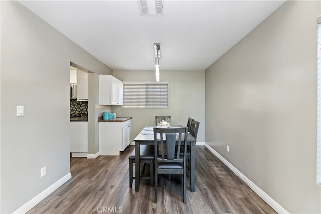 dining room featuring dark wood-type flooring