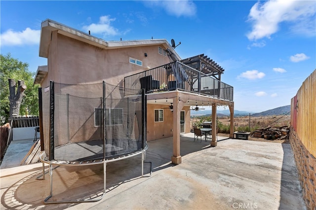 back of house with a mountain view and a patio area