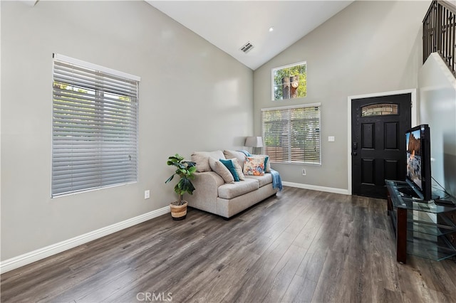 entryway with dark wood-type flooring and high vaulted ceiling