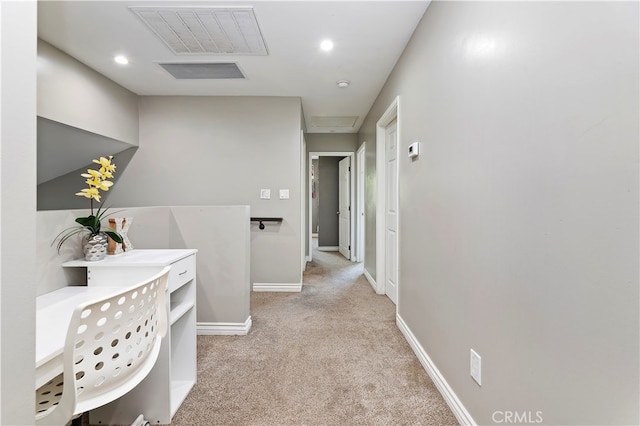 hallway with light colored carpet