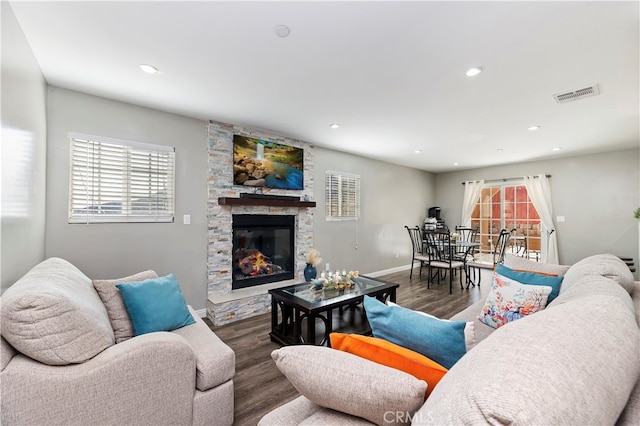 living room with a fireplace and dark hardwood / wood-style floors