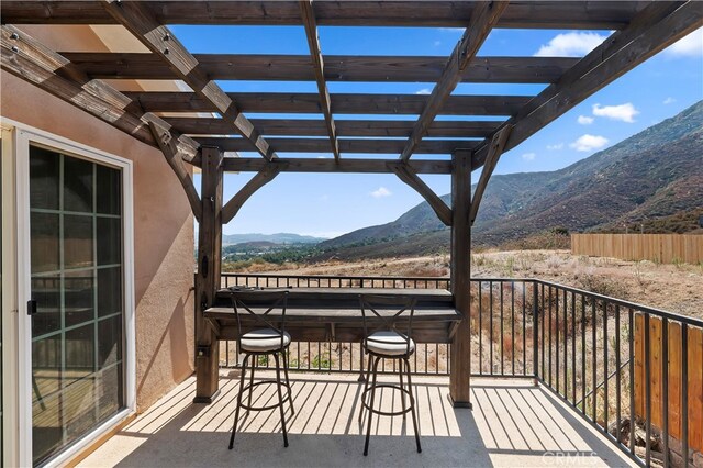 balcony featuring a pergola and a mountain view