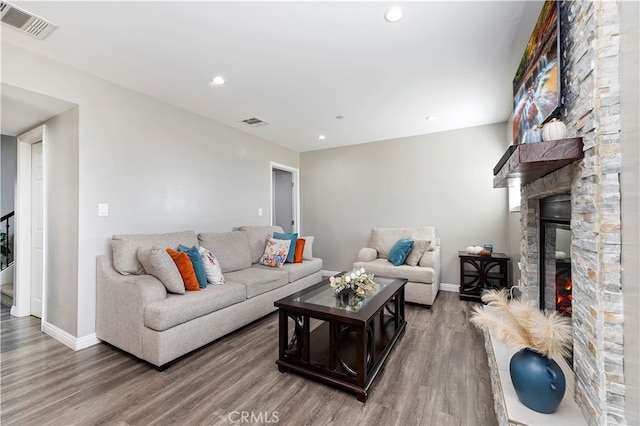 living room with a fireplace and hardwood / wood-style floors