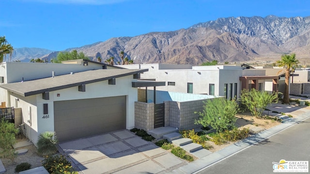 view of front of property with a mountain view and a garage