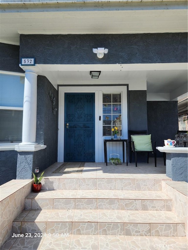 view of exterior entry with covered porch