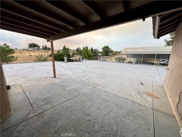 patio terrace at dusk with a carport